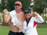 GAINESVILLE, VIRGINIA - SEPTEMBER 15: Megan Khang of the United States poses with her caddie, holding the trophy on the 18th green at the co...