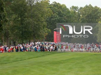 GAINESVILLE, VIRGINIA - SEPTEMBER 15: Fans cross the fairway of the seventh hole during single matches on Day Three of the Solheim Cup at Ro...