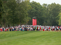 GAINESVILLE, VIRGINIA - SEPTEMBER 15: Fans cross the fairway of the seventh hole during single matches on Day Three of the Solheim Cup at Ro...