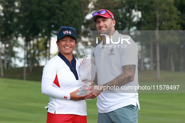 GAINESVILLE, VIRGINIA - SEPTEMBER 15: Megan Khang of the United States poses with her significant other, while holding the trophy on the 18t...