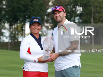 GAINESVILLE, VIRGINIA - SEPTEMBER 15: Megan Khang of the United States poses with her significant other, while holding the trophy on the 18t...