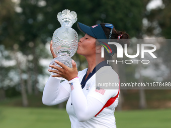 GAINESVILLE, VIRGINIA - SEPTEMBER 15: Megan Khang of the United States kisses the trophy on the 18th green at the conclusion of the Solheim...