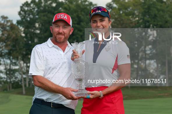 GAINESVILLE, VIRGINIA - SEPTEMBER 15: Lexi Thompson of the United States poses with her caddie, holding the trophy on the 18th green at the...