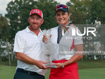 GAINESVILLE, VIRGINIA - SEPTEMBER 15: Lexi Thompson of the United States poses with her caddie, holding the trophy on the 18th green at the...