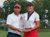 GAINESVILLE, VIRGINIA - SEPTEMBER 15: Lexi Thompson of the United States poses with her caddie, holding the trophy on the 18th green at the...