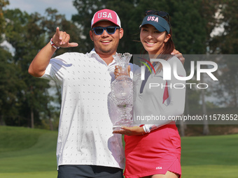 GAINESVILLE, VIRGINIA - SEPTEMBER 15: Alison Lee of the United States poses with her caddie while holding the trophy on the 18th green at th...