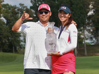 GAINESVILLE, VIRGINIA - SEPTEMBER 15: Alison Lee of the United States poses with her caddie while holding the trophy on the 18th green at th...