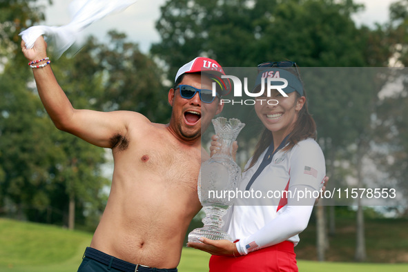 GAINESVILLE, VIRGINIA - SEPTEMBER 15: Alison Lee of the United States poses with her caddie while holding the trophy on the 18th green at th...