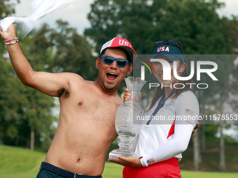 GAINESVILLE, VIRGINIA - SEPTEMBER 15: Alison Lee of the United States poses with her caddie while holding the trophy on the 18th green at th...