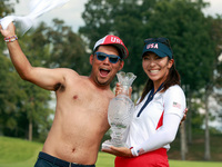 GAINESVILLE, VIRGINIA - SEPTEMBER 15: Alison Lee of the United States poses with her caddie while holding the trophy on the 18th green at th...