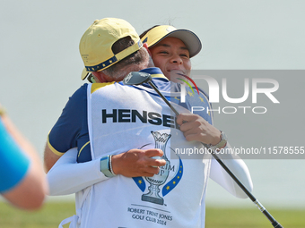 GAINESVILLE, VIRGINIA - SEPTEMBER 15: Celine Boutier of Team Europe celebrates her putt on the 18th green with her caddie during single matc...