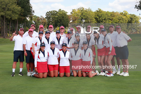 GAINESVILLE, VIRGINIA - SEPTEMBER 15: Team USA poses with their caddies as a group on the 18th green at the conclusion  of the Solheim Cup a...