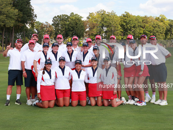 GAINESVILLE, VIRGINIA - SEPTEMBER 15: Team USA poses with their caddies as a group on the 18th green at the conclusion  of the Solheim Cup a...