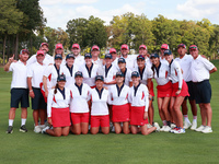 GAINESVILLE, VIRGINIA - SEPTEMBER 15: Team USA poses with their caddies as a group on the 18th green at the conclusion  of the Solheim Cup a...