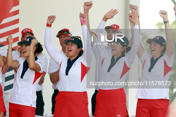 GAINESVILLE, VIRGINIA - SEPTEMBER 15: Some of the members of Team USA cheer during the award ceremony at the conclusion of the Solheim Cup a...