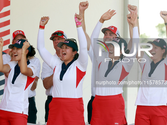 GAINESVILLE, VIRGINIA - SEPTEMBER 15: Some of the members of Team USA cheer during the award ceremony at the conclusion of the Solheim Cup a...