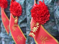 New recruits wearing red flowers attend a send-off ceremony at the Yongnian district militia training base in Handan, China, on September 14...