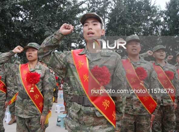 New recruits take a solemn oath at the militia training base in Yongnian district, Handan, China, on September 14, 2024. 