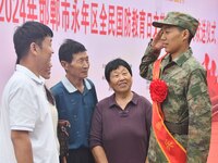 A new recruit salutes his family at a militia training base in Yongnian district of Handan, China, on September 14, 2024. (