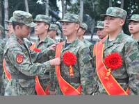 A staff member arranges ribbons for new recruits at the militia training base in Yongnian district of Handan, in Handan, China, on September...