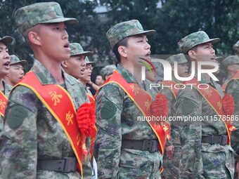 New recruits sing the national anthem at the militia training base in Yongnian district of Handan, in Handan, China, on September 14, 2024....