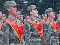 New recruits sing the national anthem at the militia training base in Yongnian district of Handan, in Handan, China, on September 14, 2024....