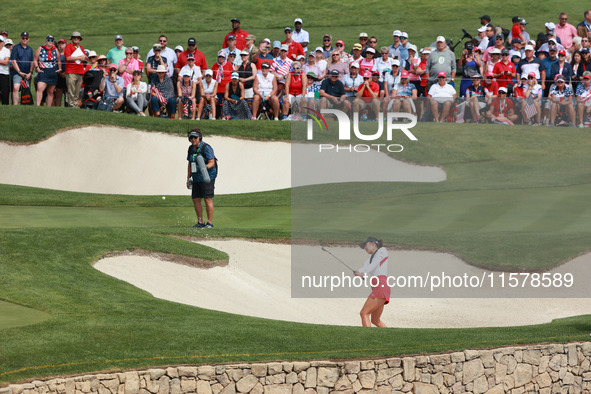 GAINESVILLE, VIRGINIA - SEPTEMBER 15: Alison Lee of the United States hits out of the bunker toward the 14th green during single matches on...