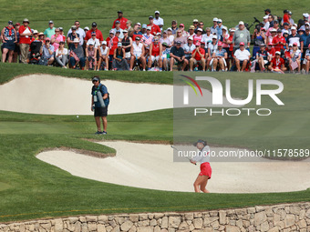 GAINESVILLE, VIRGINIA - SEPTEMBER 15: Alison Lee of the United States hits out of the bunker toward the 14th green during single matches on...