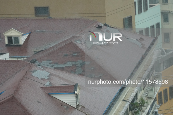 Part of the roof surface is blown by strong winds in Yangpu district, in Shanghai, China, on September 16, 2024. 