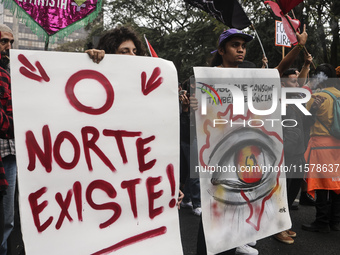 Protesters hold a demonstration against the fires and the climate situation in Brazil and for agrarian reform on Avenida Paulista, in the ce...