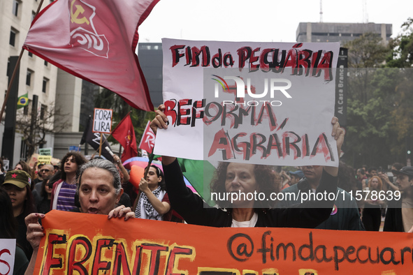 Protesters hold a demonstration against the fires and the climate situation in Brazil and for agrarian reform on Avenida Paulista, in the ce...