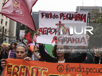 Protesters hold a demonstration against the fires and the climate situation in Brazil and for agrarian reform on Avenida Paulista, in the ce...