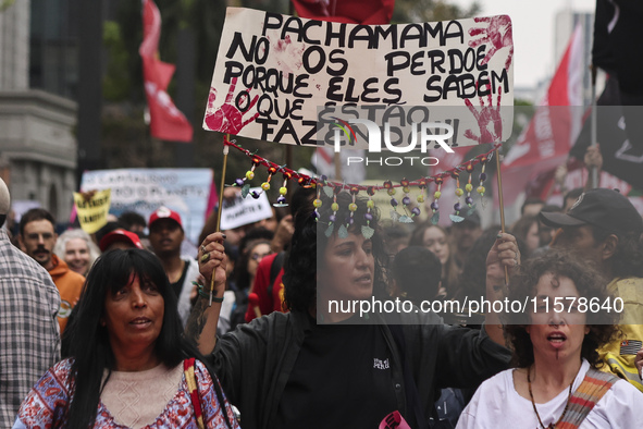 Protesters hold a demonstration against the fires and the climate situation in Brazil and for agrarian reform on Avenida Paulista, in the ce...