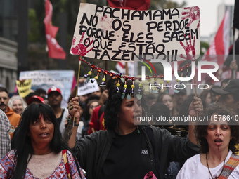 Protesters hold a demonstration against the fires and the climate situation in Brazil and for agrarian reform on Avenida Paulista, in the ce...