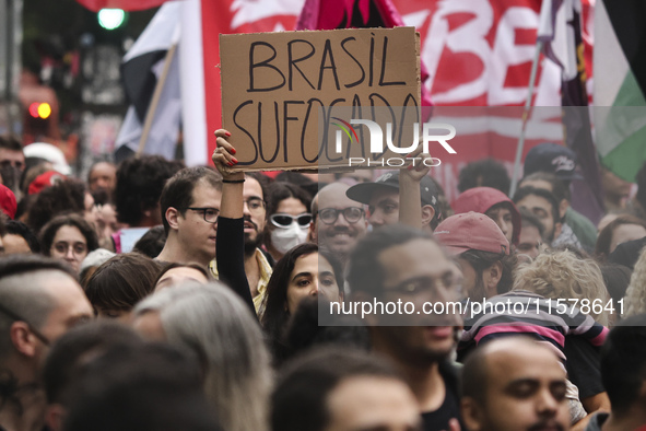 Protesters hold a demonstration against the fires and the climate situation in Brazil and for agrarian reform on Avenida Paulista, in the ce...