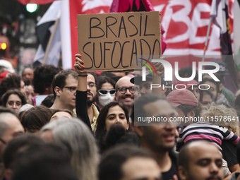 Protesters hold a demonstration against the fires and the climate situation in Brazil and for agrarian reform on Avenida Paulista, in the ce...