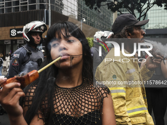 Protesters hold a demonstration against the fires and the climate situation in Brazil and for agrarian reform on Avenida Paulista, in the ce...