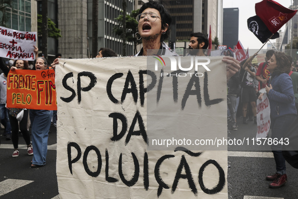 Protesters hold a demonstration against the fires and the climate situation in Brazil and for agrarian reform on Avenida Paulista, in the ce...