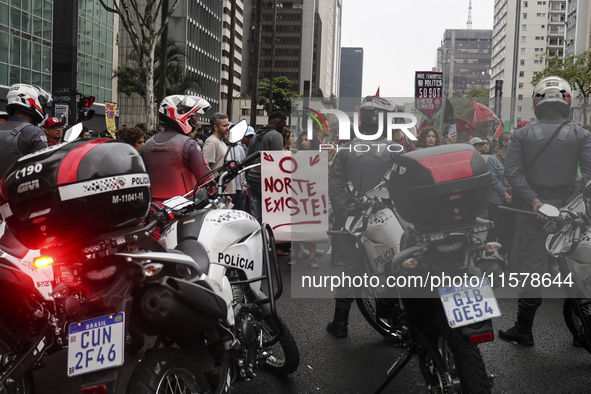 Protesters hold a demonstration against the fires and the climate situation in Brazil and for agrarian reform on Avenida Paulista, in the ce...