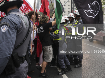 Protesters hold a demonstration against the fires and the climate situation in Brazil and for agrarian reform on Avenida Paulista, in the ce...