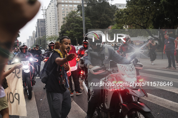 Protesters hold a demonstration against the fires and the climate situation in Brazil and for agrarian reform on Avenida Paulista, in the ce...