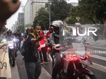 Protesters hold a demonstration against the fires and the climate situation in Brazil and for agrarian reform on Avenida Paulista, in the ce...