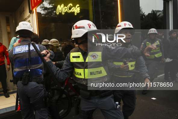 Protesters hold a demonstration against the fires and the climate situation in Brazil and for agrarian reform on Avenida Paulista, in the ce...