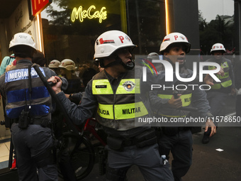 Protesters hold a demonstration against the fires and the climate situation in Brazil and for agrarian reform on Avenida Paulista, in the ce...