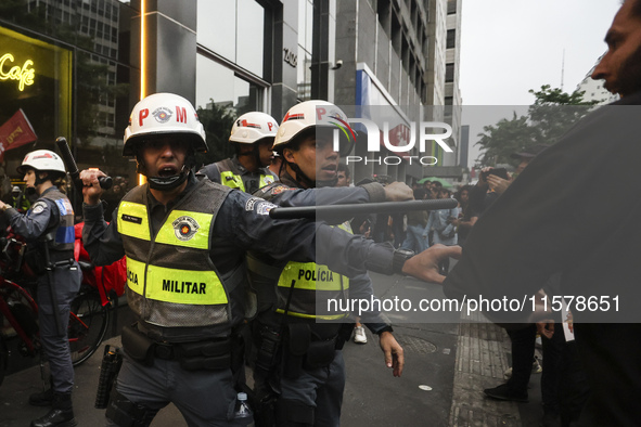 Protesters hold a demonstration against the fires and the climate situation in Brazil and for agrarian reform on Avenida Paulista, in the ce...