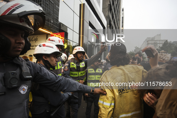 Protesters hold a demonstration against the fires and the climate situation in Brazil and for agrarian reform on Avenida Paulista, in the ce...