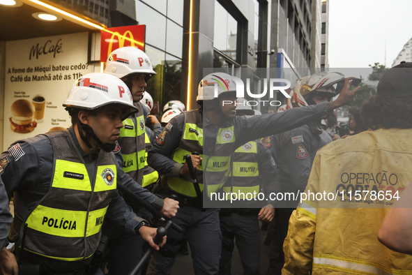 Protesters hold a demonstration against the fires and the climate situation in Brazil and for agrarian reform on Avenida Paulista, in the ce...