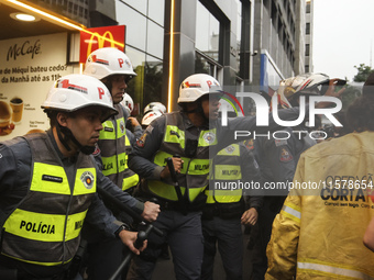 Protesters hold a demonstration against the fires and the climate situation in Brazil and for agrarian reform on Avenida Paulista, in the ce...