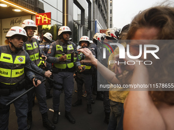 Protesters hold a demonstration against the fires and the climate situation in Brazil and for agrarian reform on Avenida Paulista, in the ce...