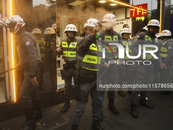 Protesters hold a demonstration against the fires and the climate situation in Brazil and for agrarian reform on Avenida Paulista, in the ce...